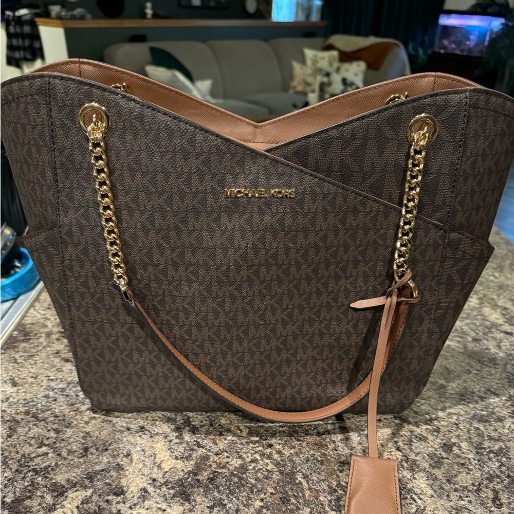 Michael Kors Jet Set Travel tote in brown with gold hardware.